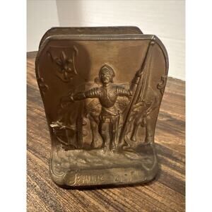 vintage cast iron bookend depicts Joan of Arc bronze colored